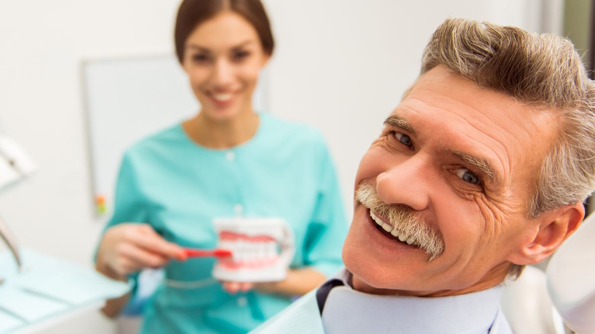Dental Hygienist explaining how to brush dentures. Las Vegas, NV
